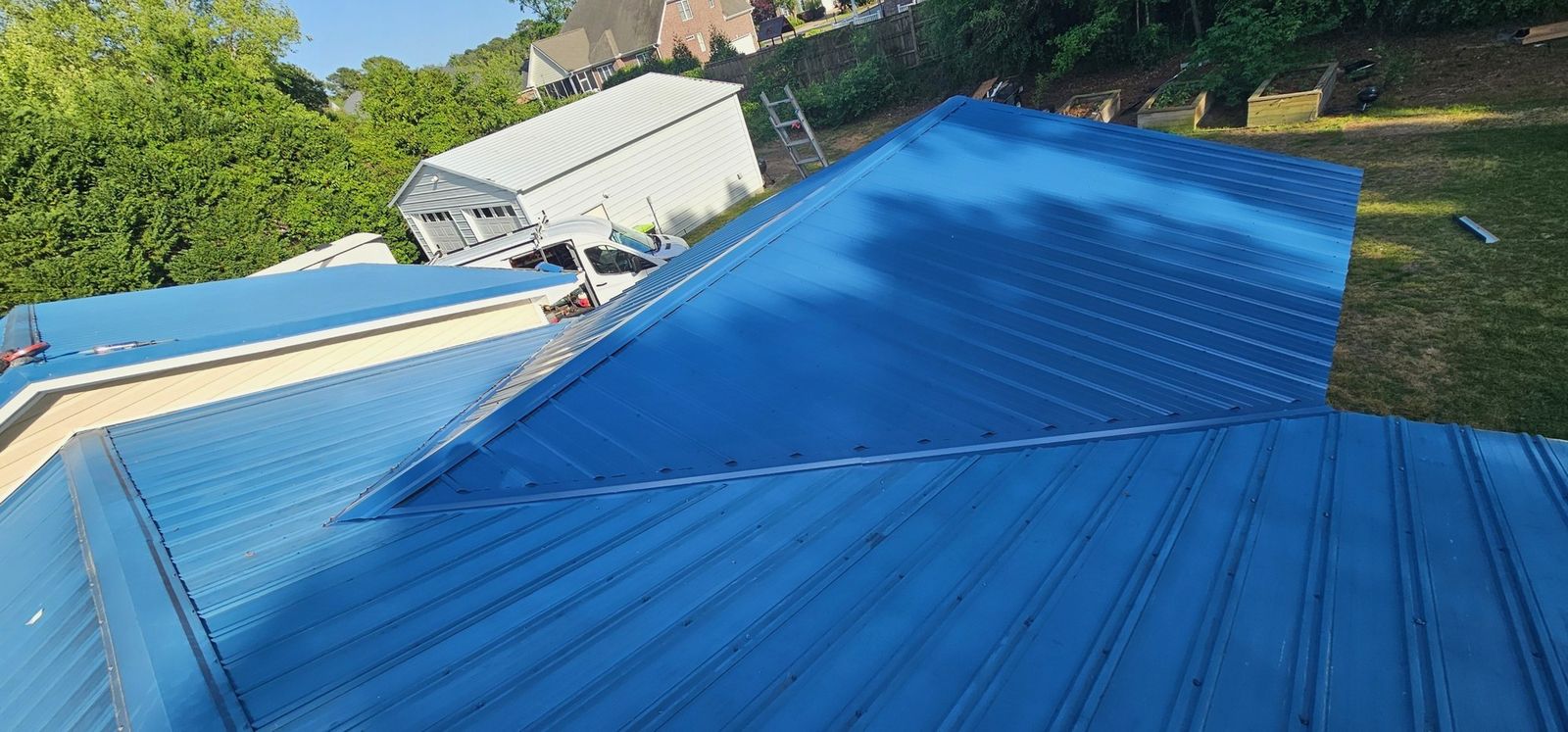 Blue metal roof panel slope on a residential roof