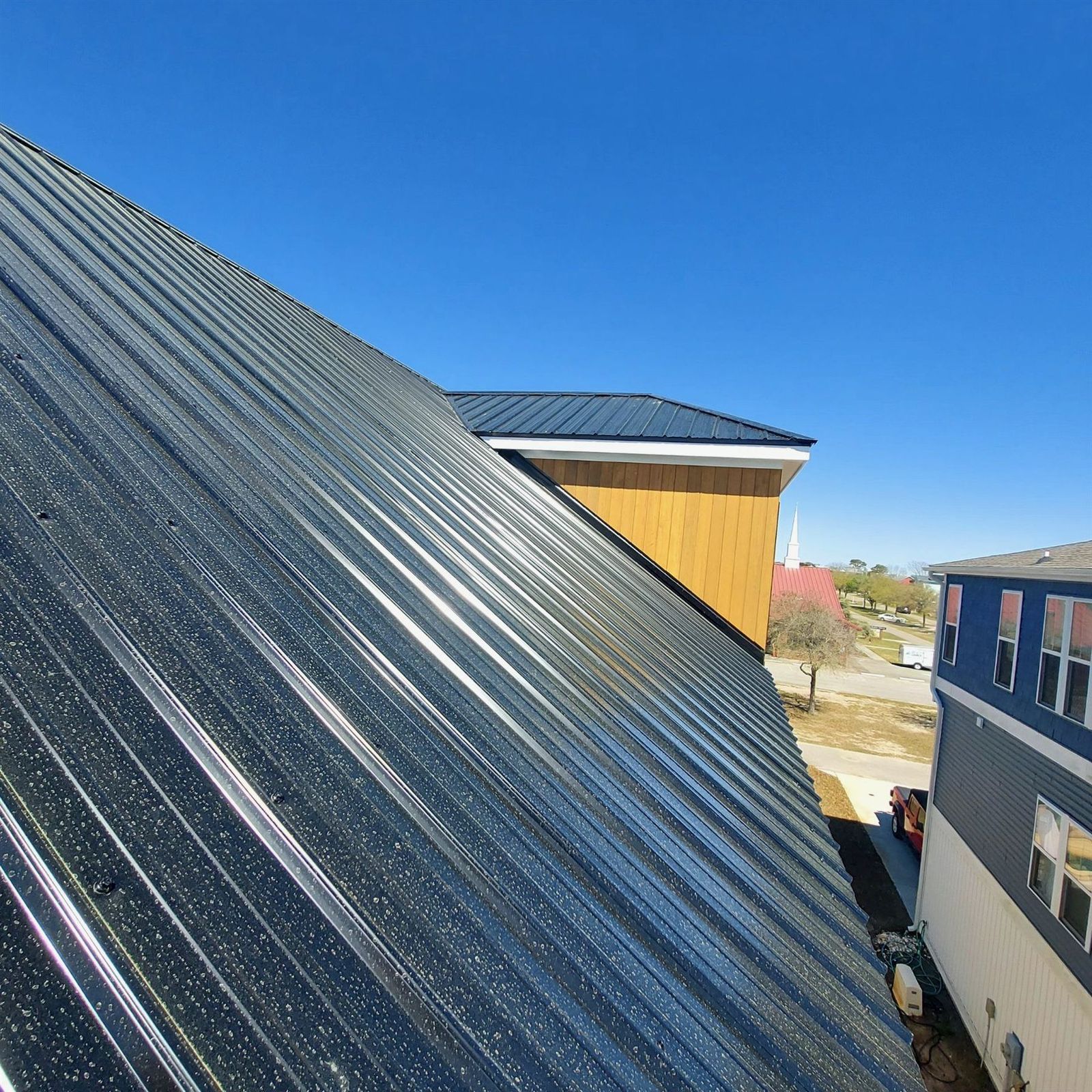 Sunlit dark metal roof slope detail