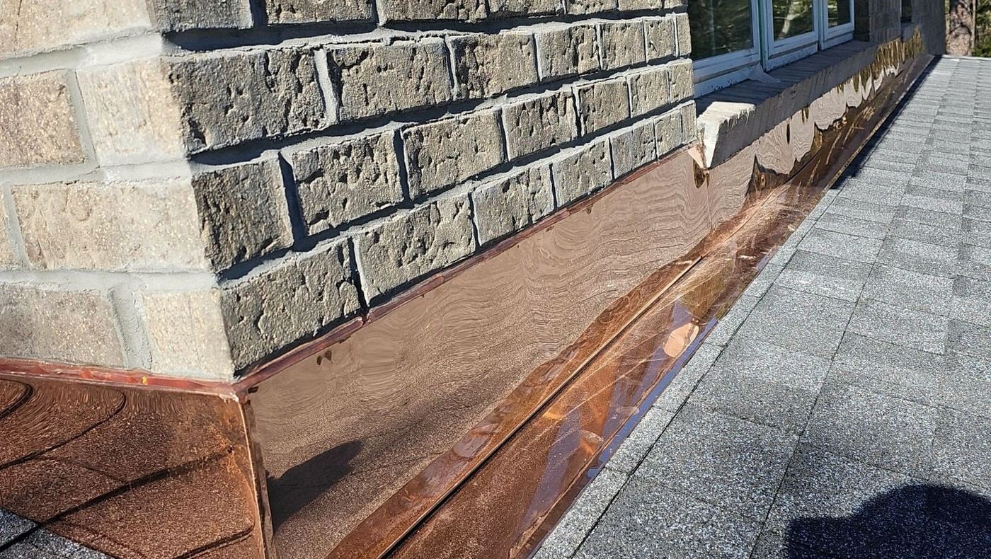 Copper flashing detail installed along a roof edge