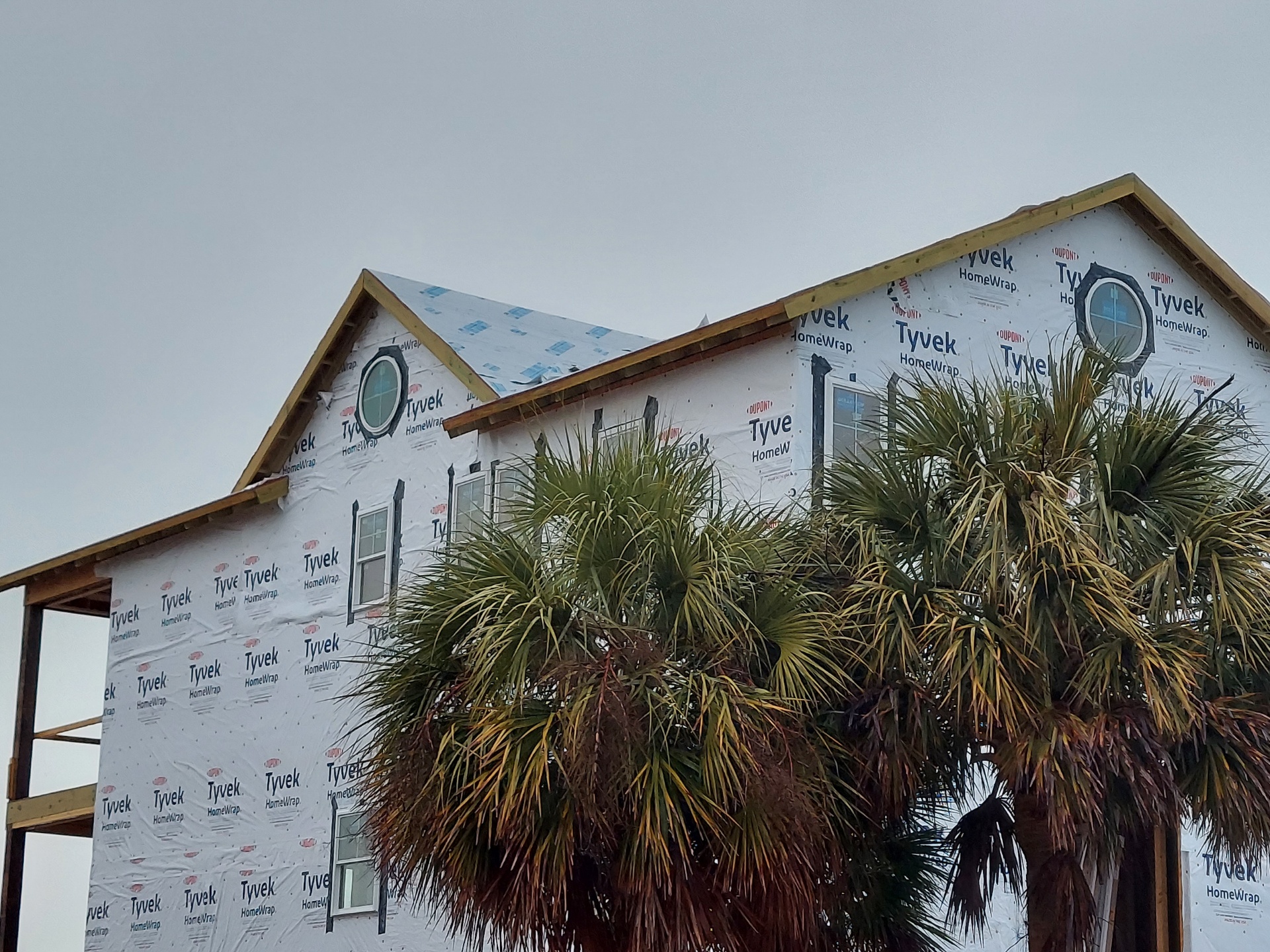 New construction house wrap before exterior roof details are finished