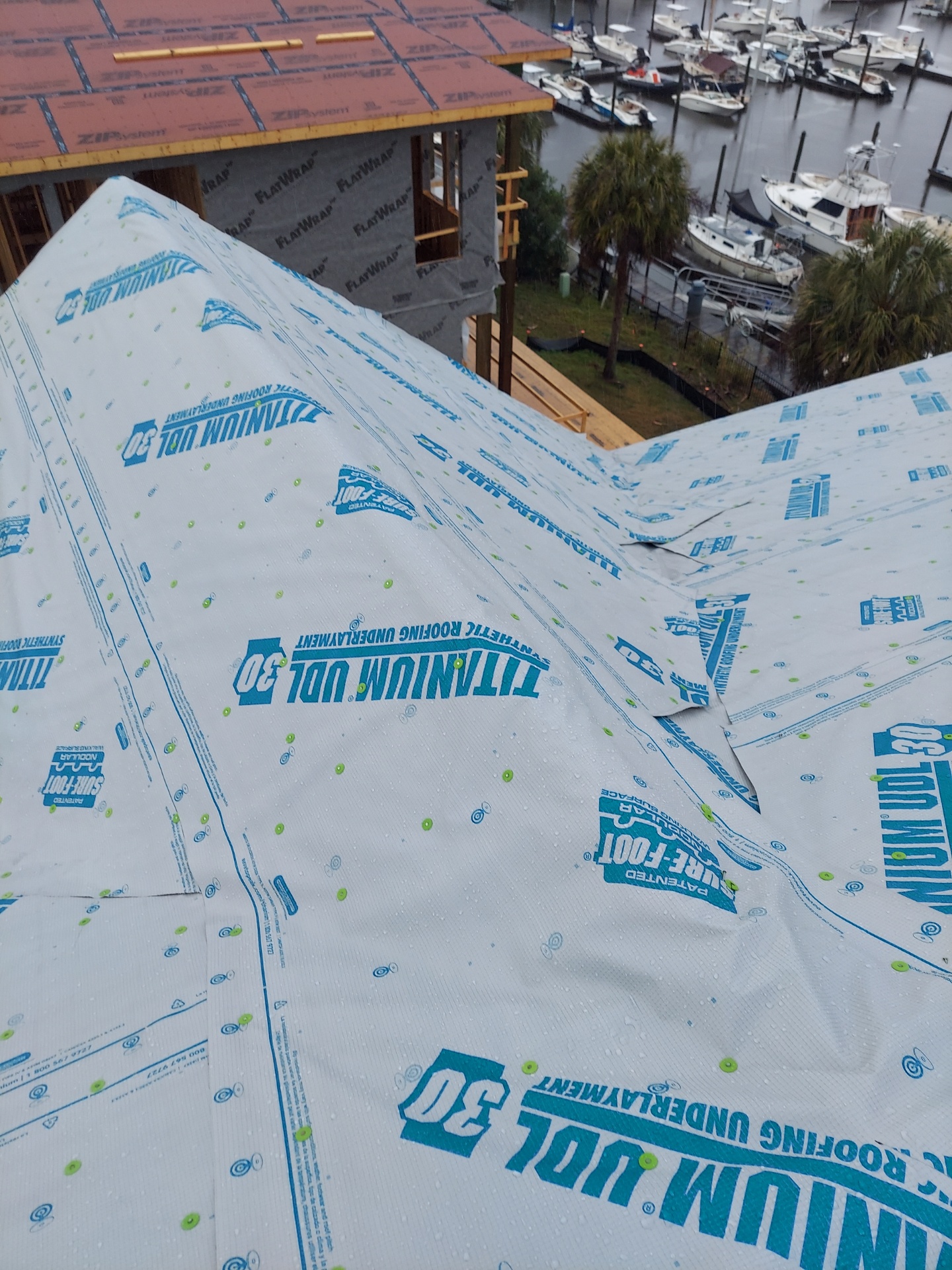 Roof underlayment across a prepared roof slope during roof preparation